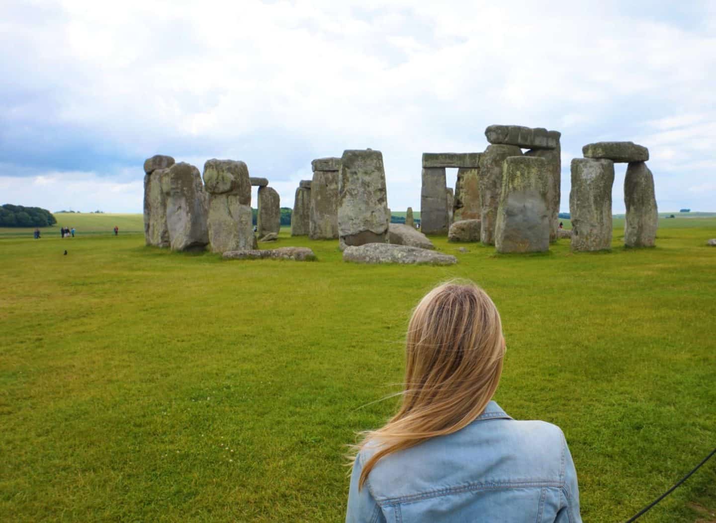 ellie quinn infront of stonehenge on a rainy and cloudy day