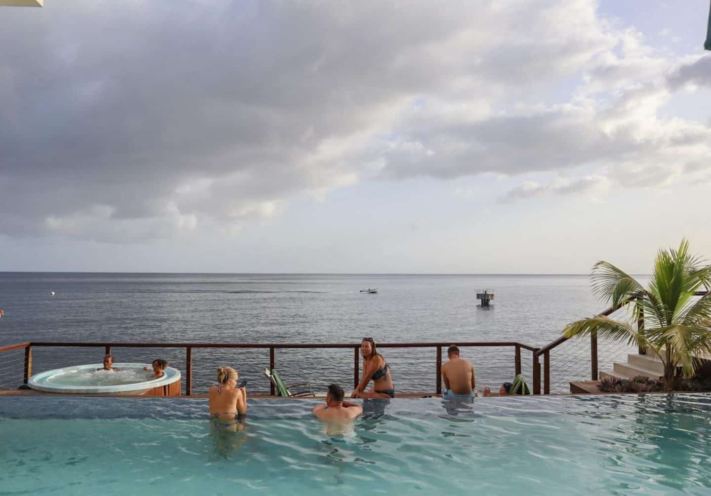 dominica travel guide, fort young hotel pool and ocean with rain clouds above in July