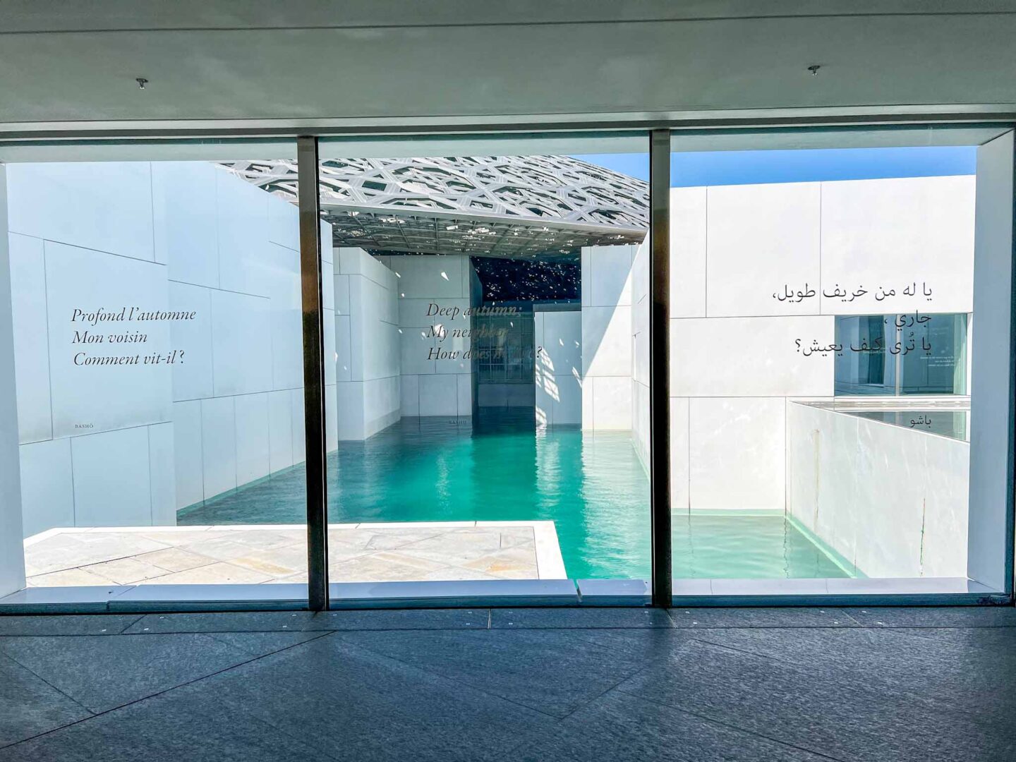 Things to do in Abu Dhabi, inside The Louvre with water around the museum