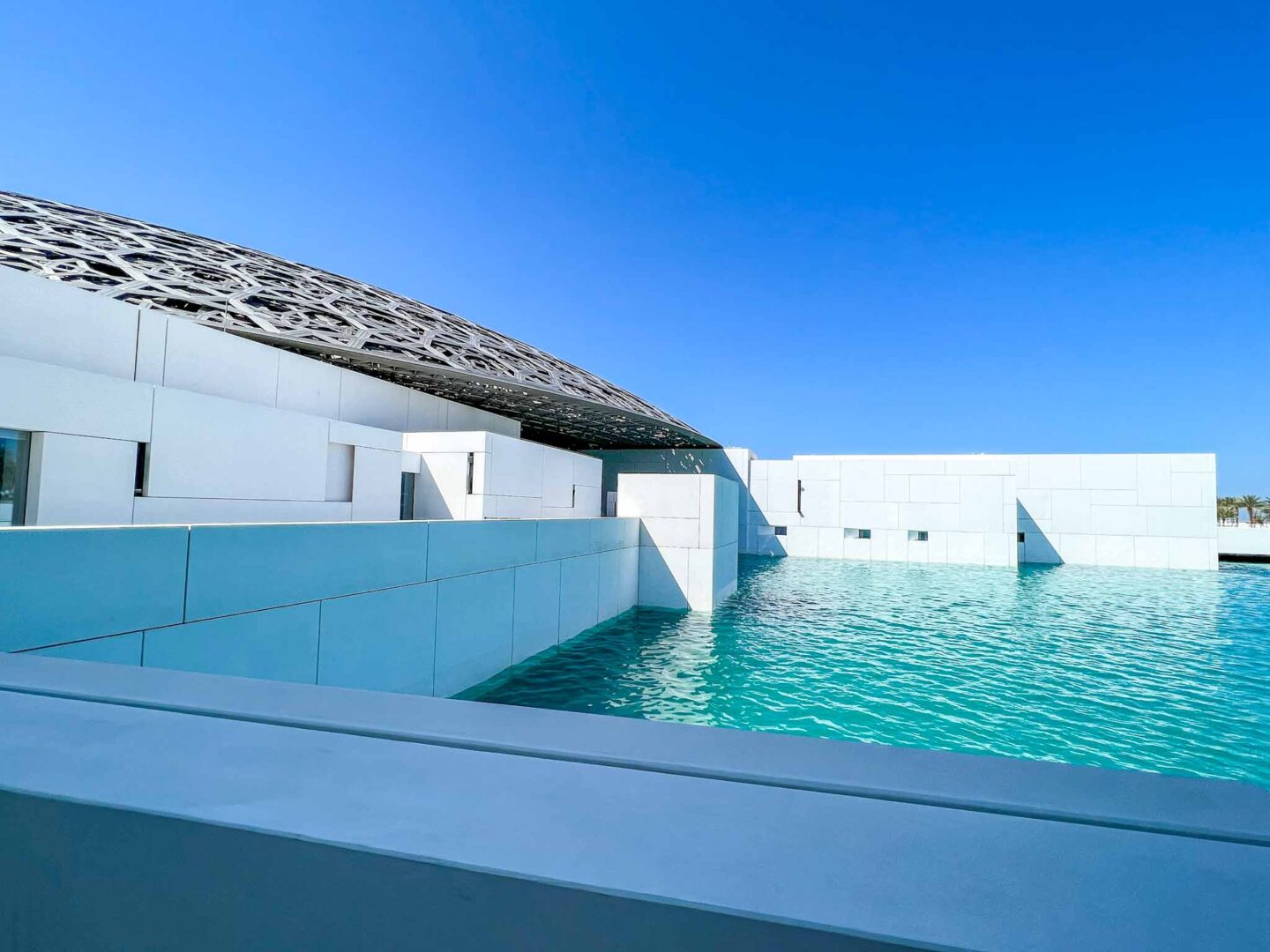 Things to do in Abu Dhabi, The Louvre from outside with blue water