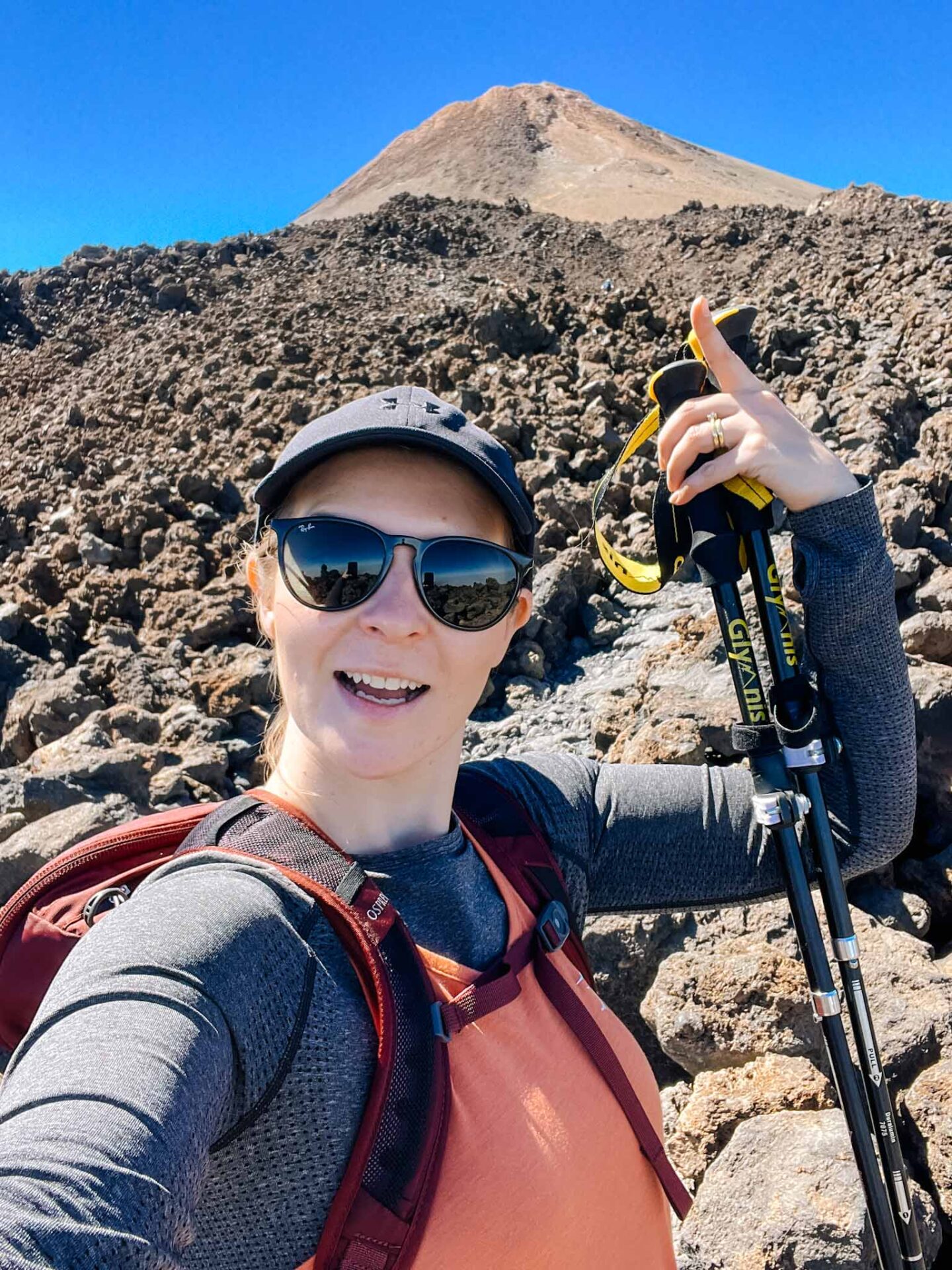 Hiking Mount Teide, Ellie pointing to top of Mount Teide