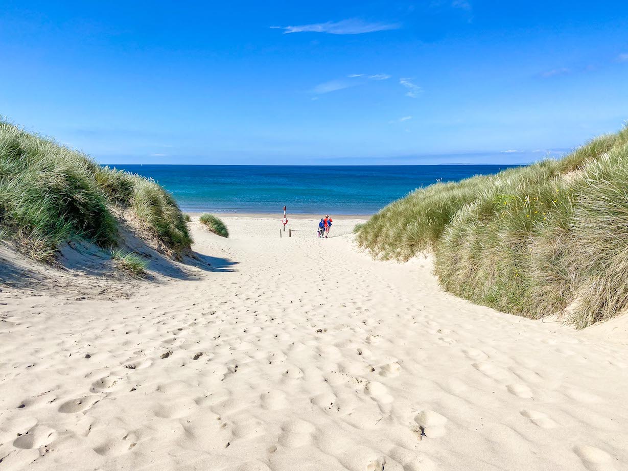 places to visit in North Wales, Harlech Beach with white sand and blue sky