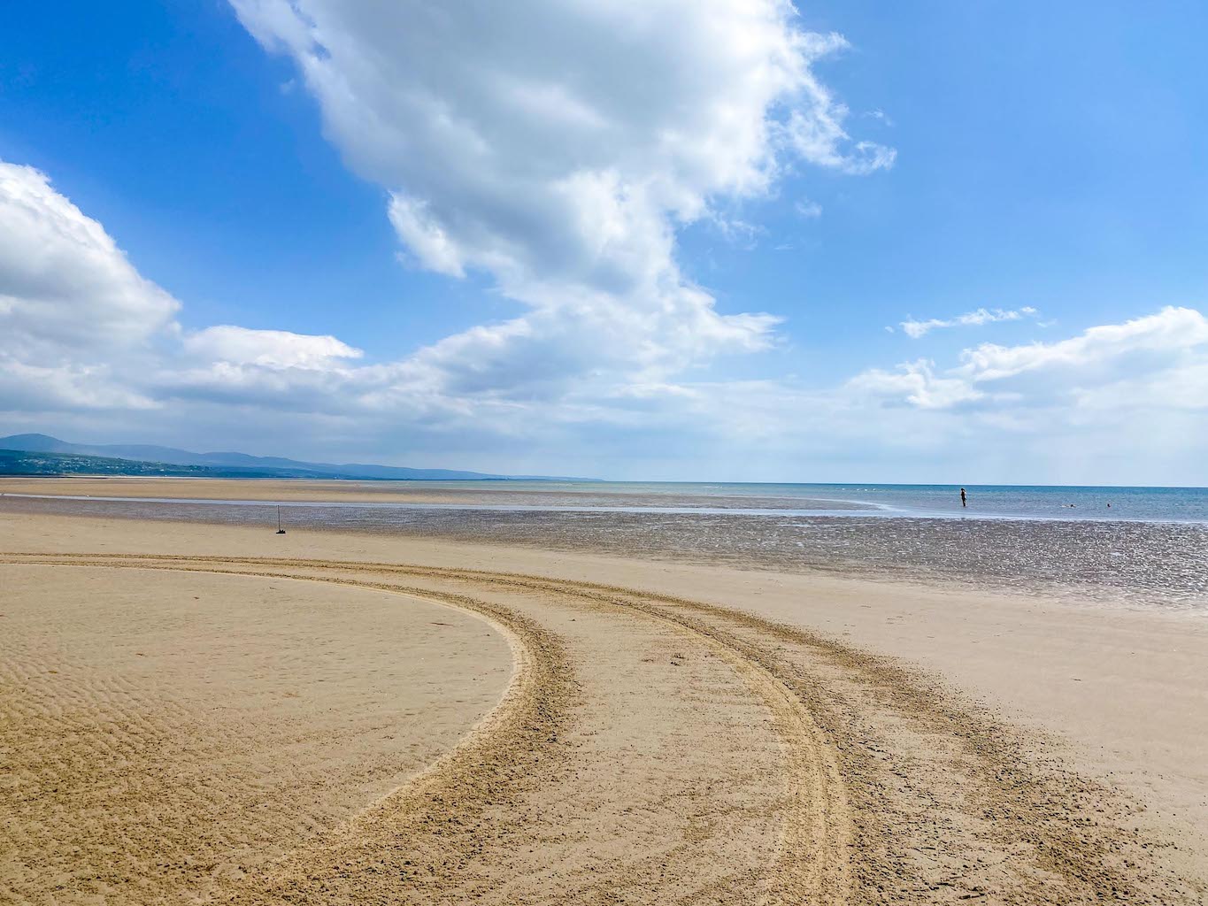The Wandering Quinn Travel Blog places to visit in North Wales, Black Rock Sands Beach with tyre marks on sand