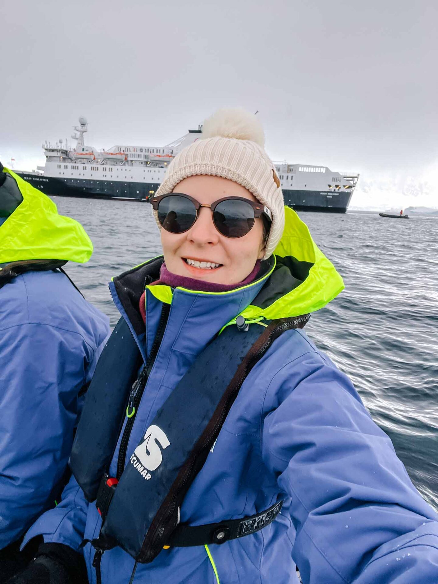 Ellie with hat, sunglasses and buff on in Antarctica, What to wear in Antarctica, What to pack for Antarctica,