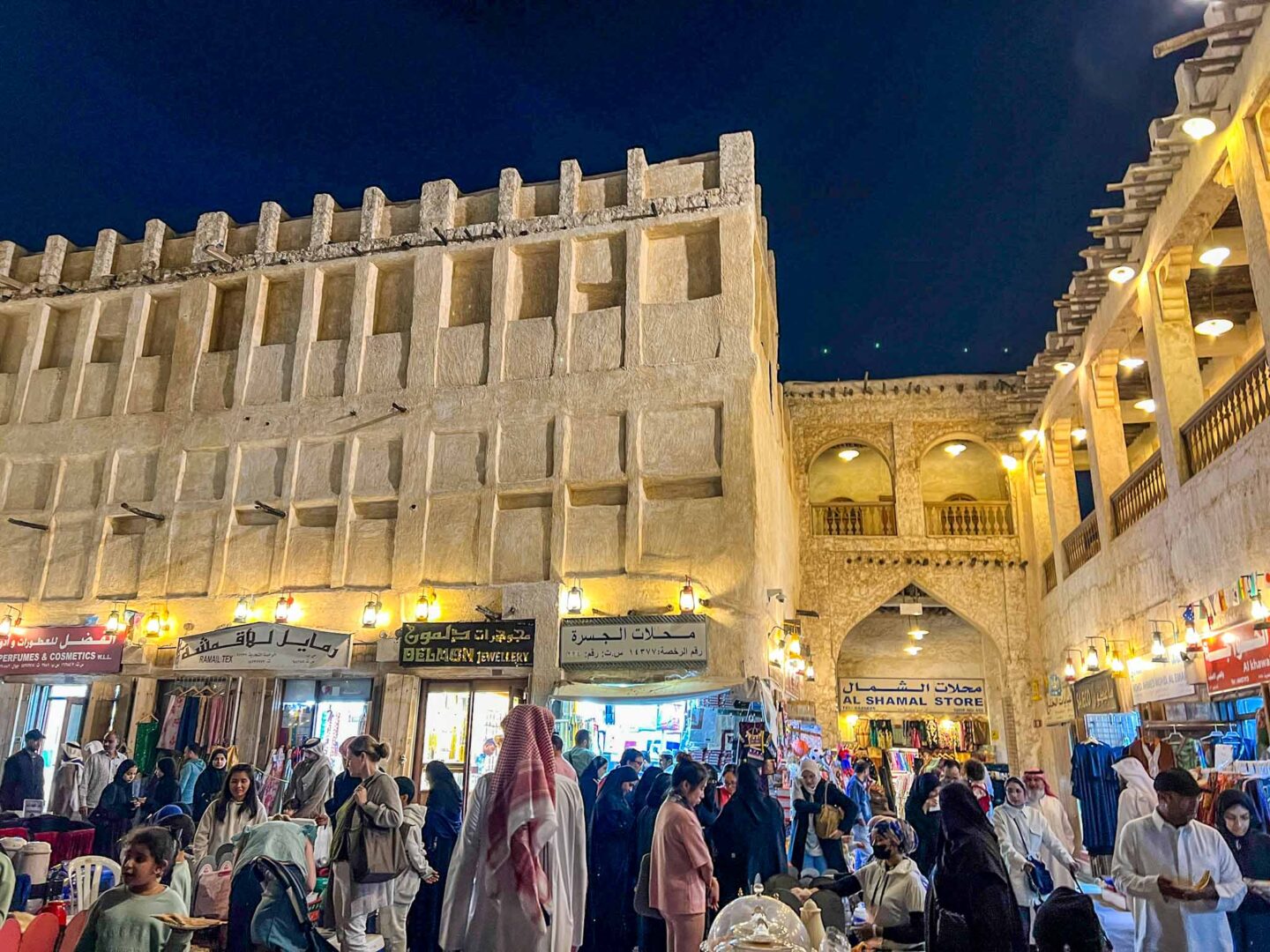 Locals and tourists in Souq Waqif at night, Qatar dress code, what to wear in Qatar,