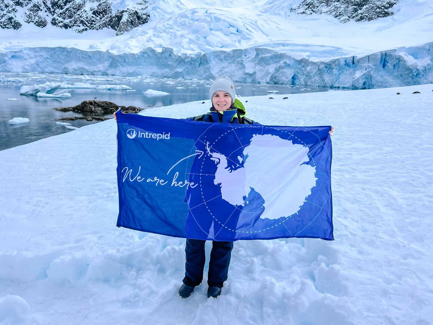Ellie with Antarctica flag, 7th continent, Can you visit Antarctica, Why do people visit Antarctica, 