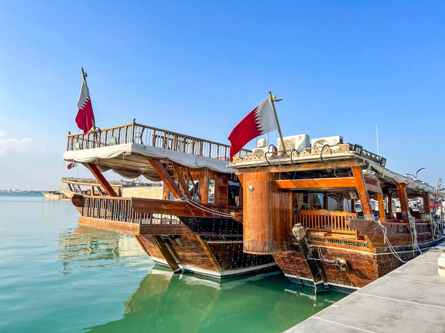 side of Dhow Boats in doha with Qatar flag, Doha itinerary, Qatar itinerary