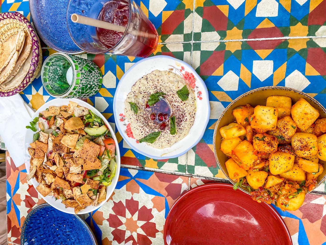 halal restaurants in manchester, selection of food from Comptoir Libanais on colourful table