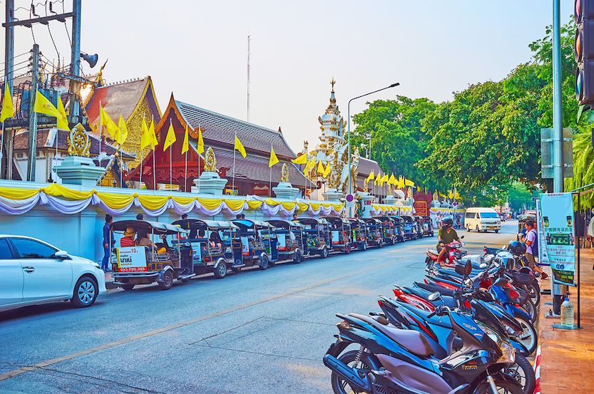 Tuk Tuk parking at wall of Wat Chedi Luang, on May 3 in Chiang Mai, what is chiang mai known for, chiang mai must see spots