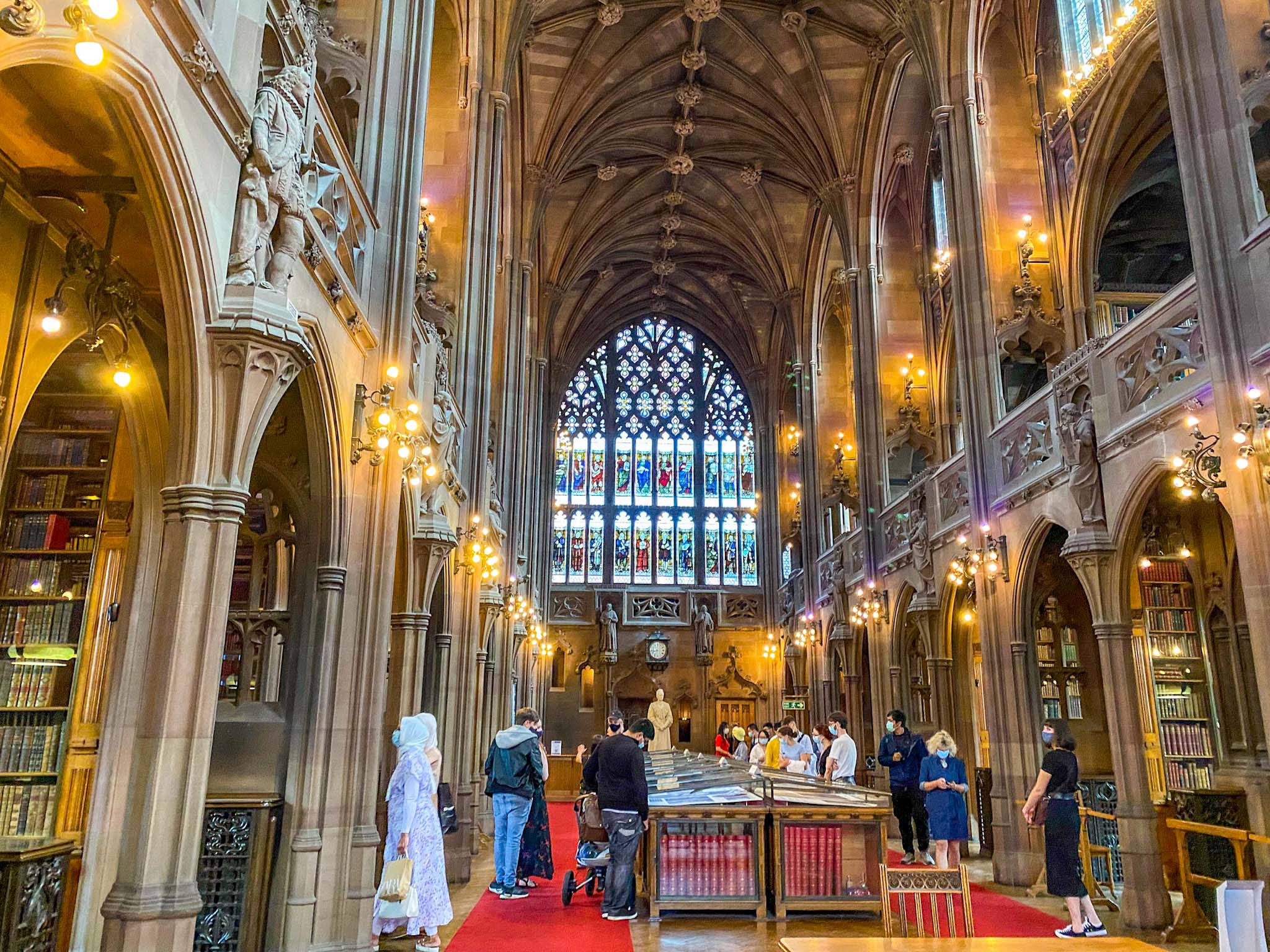 inside the hall of John Rylands Library, playing inside treetops adventure golf, Family Days Out in Manchester, Manchester with kids,