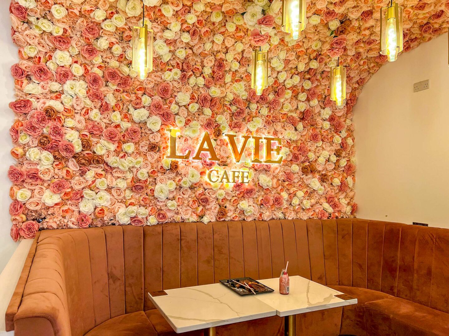 Halal brunch manchester, Inside La Vie Cafe with flowers on wall