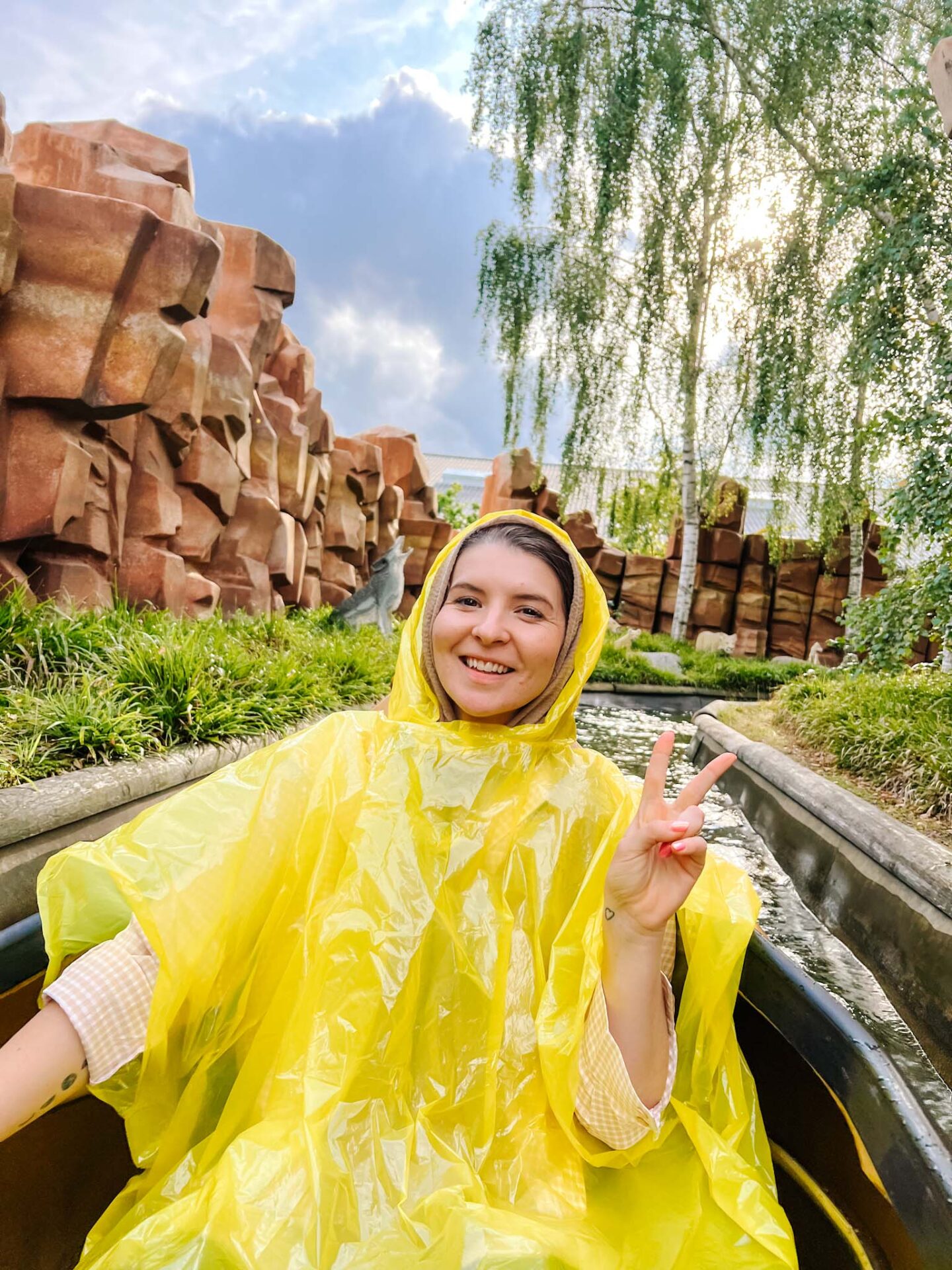 how to visit LEGOLAND Billund, Ellie in poncho on canoe water ride