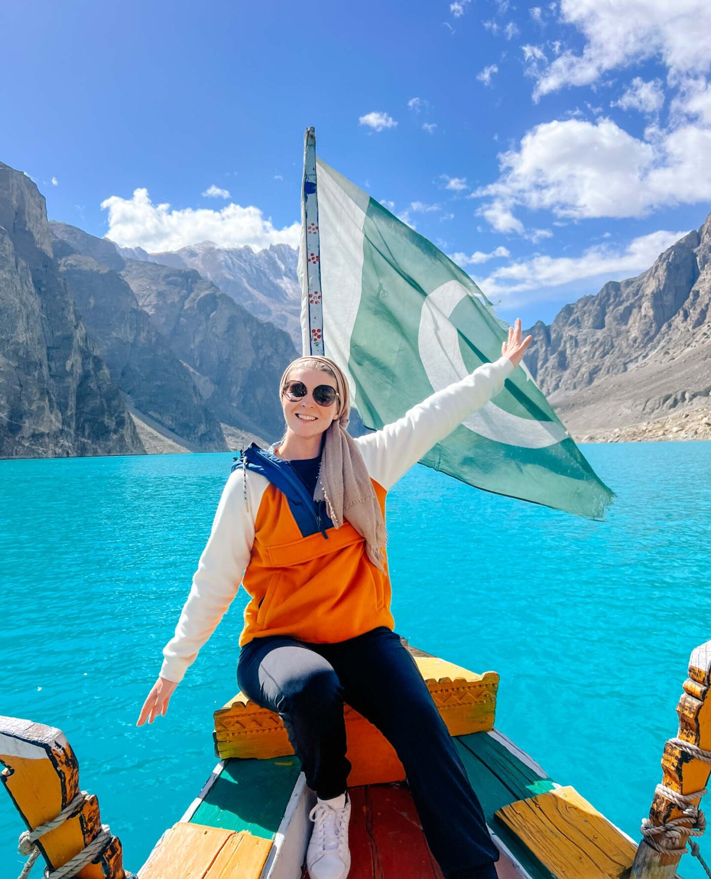 Ellie on Attabad lake with Pakistan flag, what to wear in Pakistan