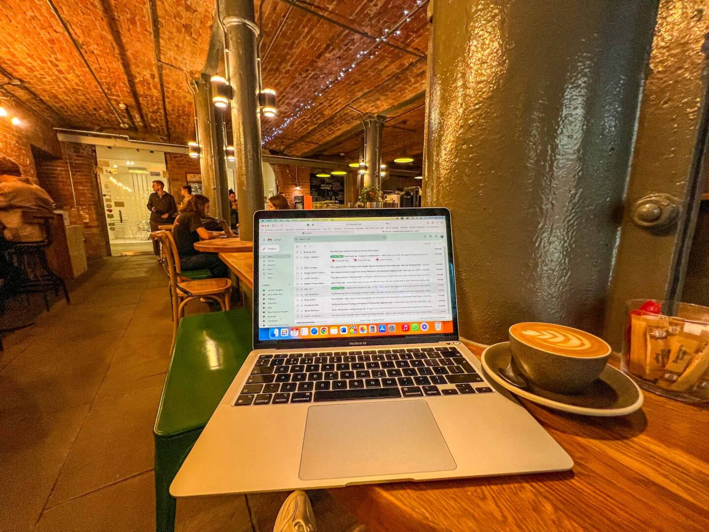 Manchester cafes to work from, Ancoats Coffee inside with laptop and coffee