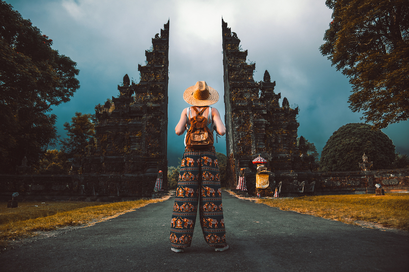 Packing List Bali, female at temple gates in Bali in elephant pants