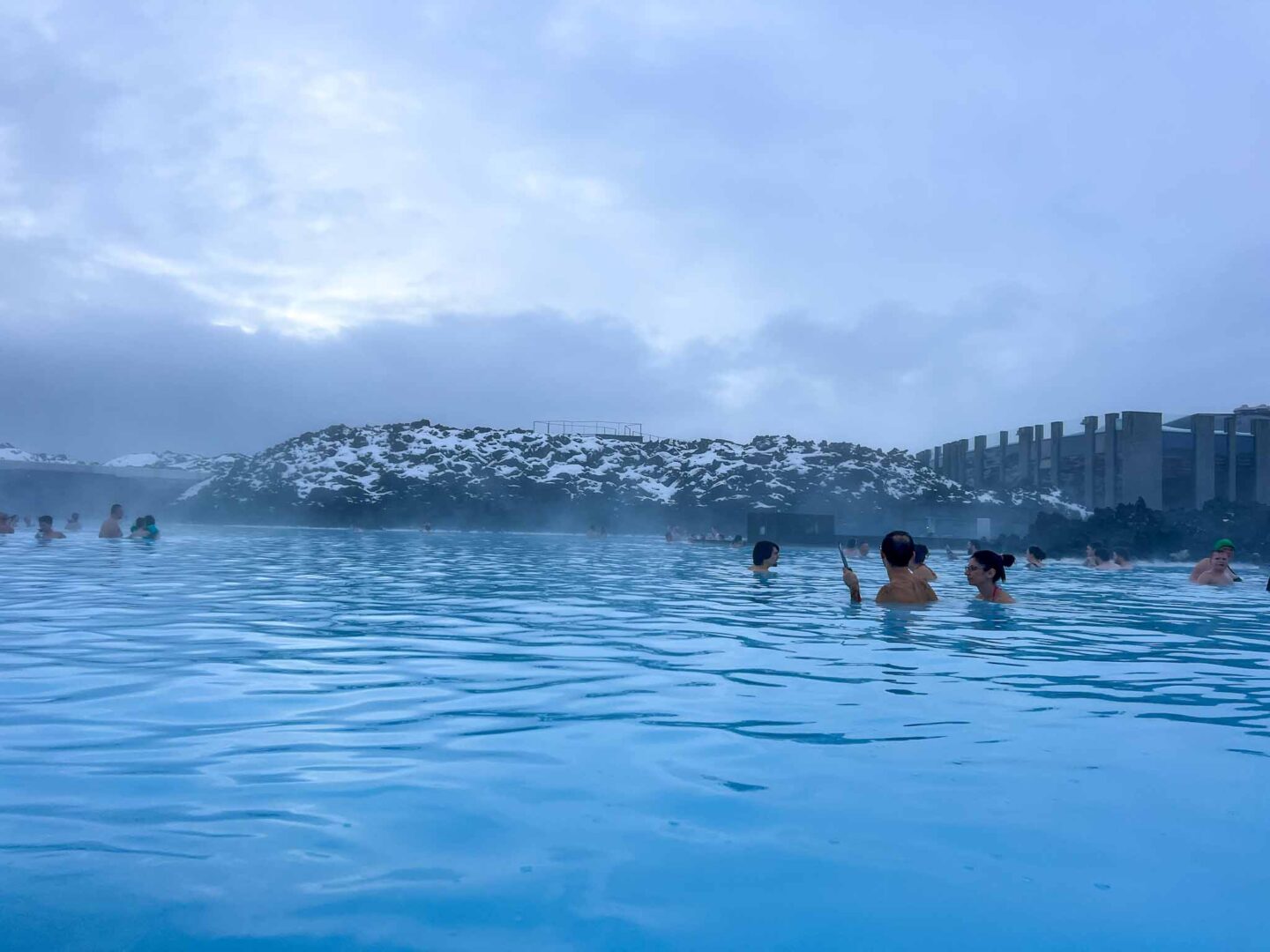 The Wandering Quinn Travel Blog Visiting the Blue Lagoon, blue lagoon with snow nearby