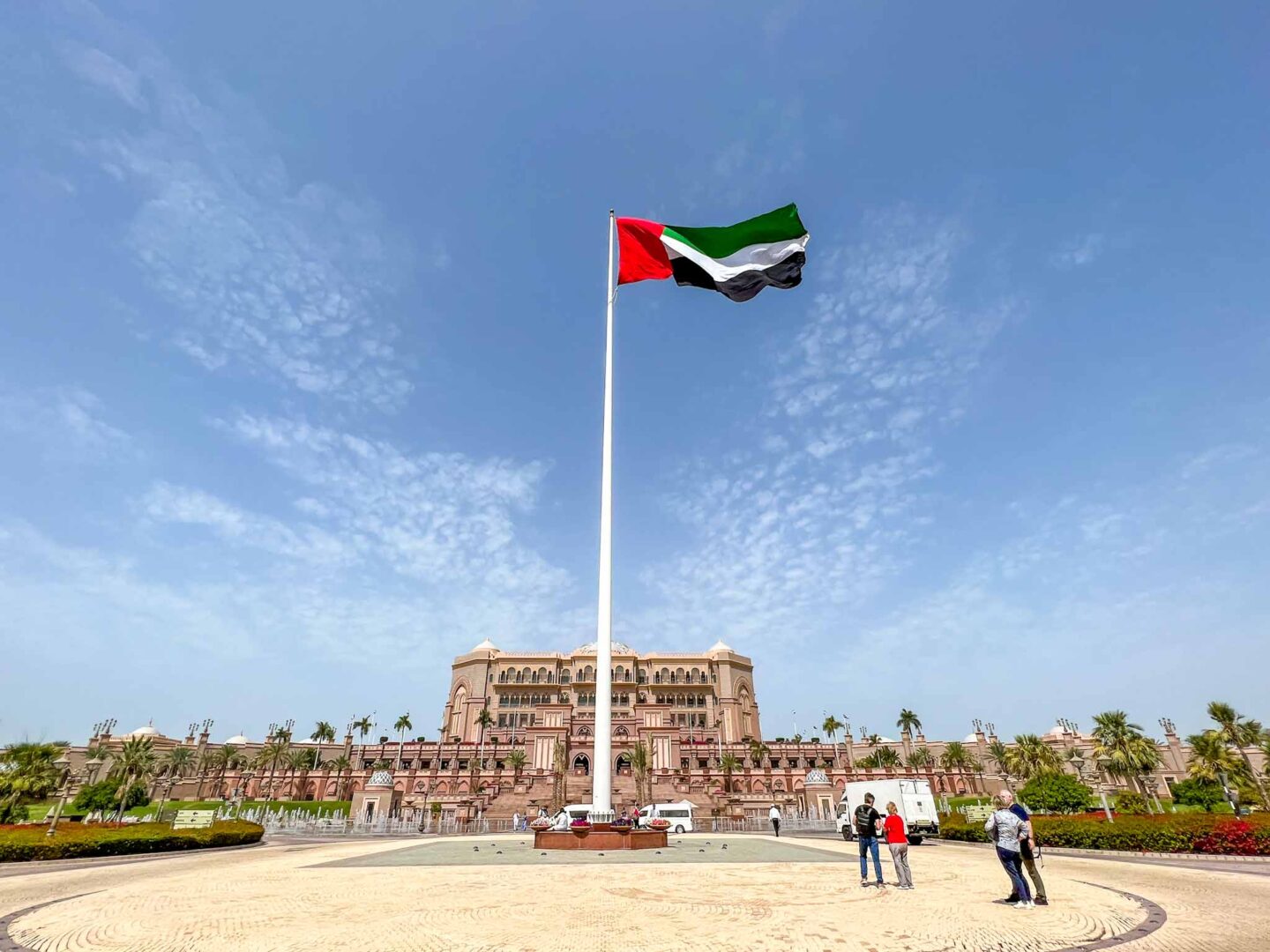 The Wandering Quinn Travel Blog Dubai vs Abu Dhabi, Emirates Palace with UAE flag outside