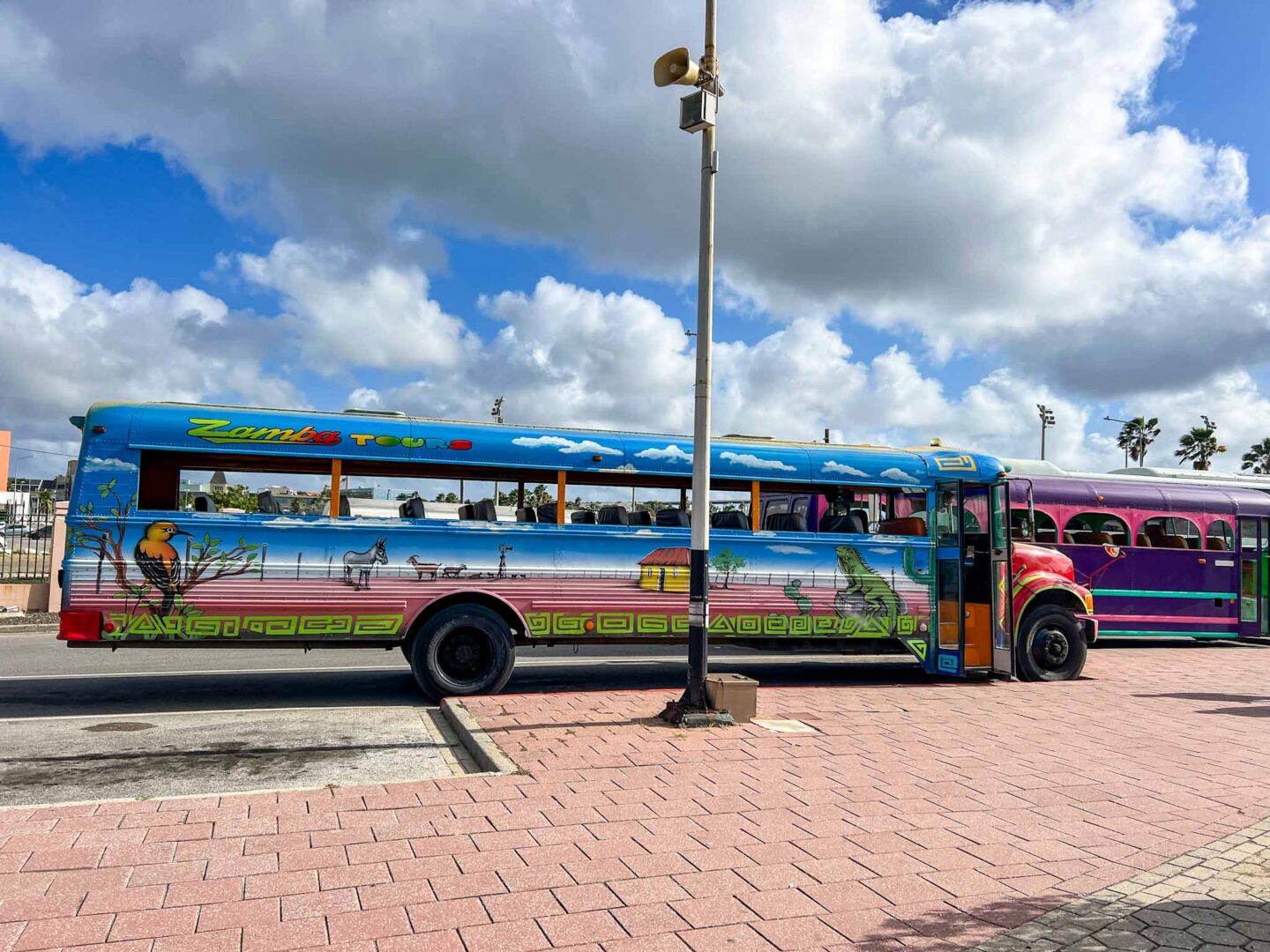 The Wandering Quinn Travel Blog how to see islands on a Caribbean cruise, colourful tourist bus in Willemtsad Curacao,  