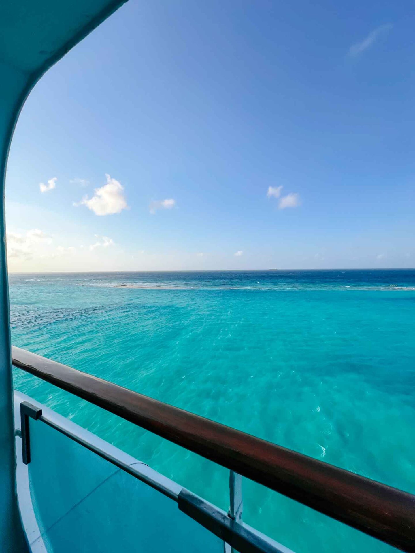 The Wandering Quinn Travel Blog Tui cruise review, bright blue Aruba waters from my balcony onboard Marella Discovery 2