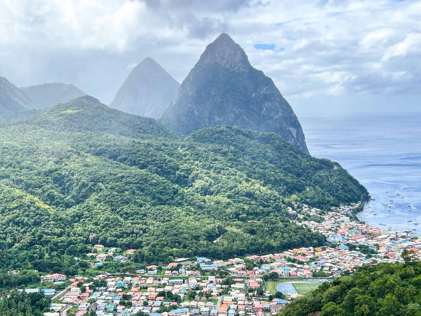 The Wandering Quinn Travel Blog how to see islands on a Caribbean cruise, St Lucia pitons with village below