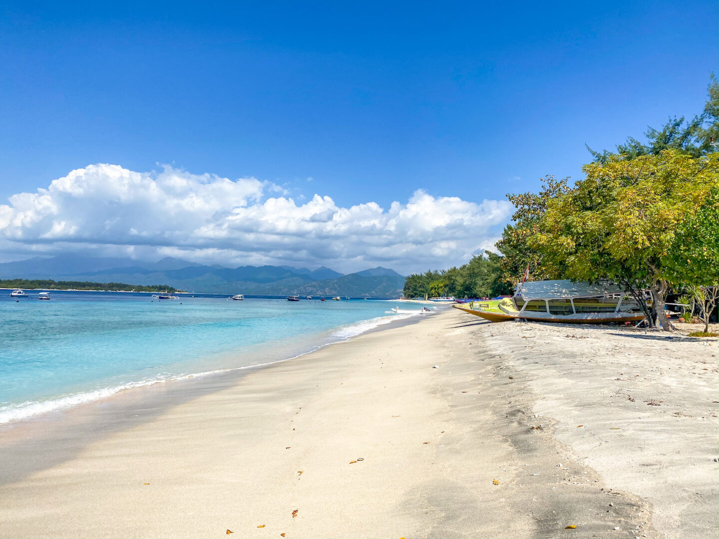 Best countries to visit in August, beach with white sand and blue water on Gili Trawangan 