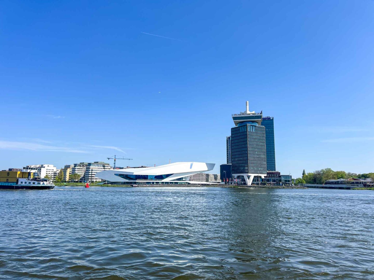 The Wandering Quinn Travel Blog Things to do in Amsterdam Noord, view of the eye filmmuseum and A'DAM lookout tower from the River 