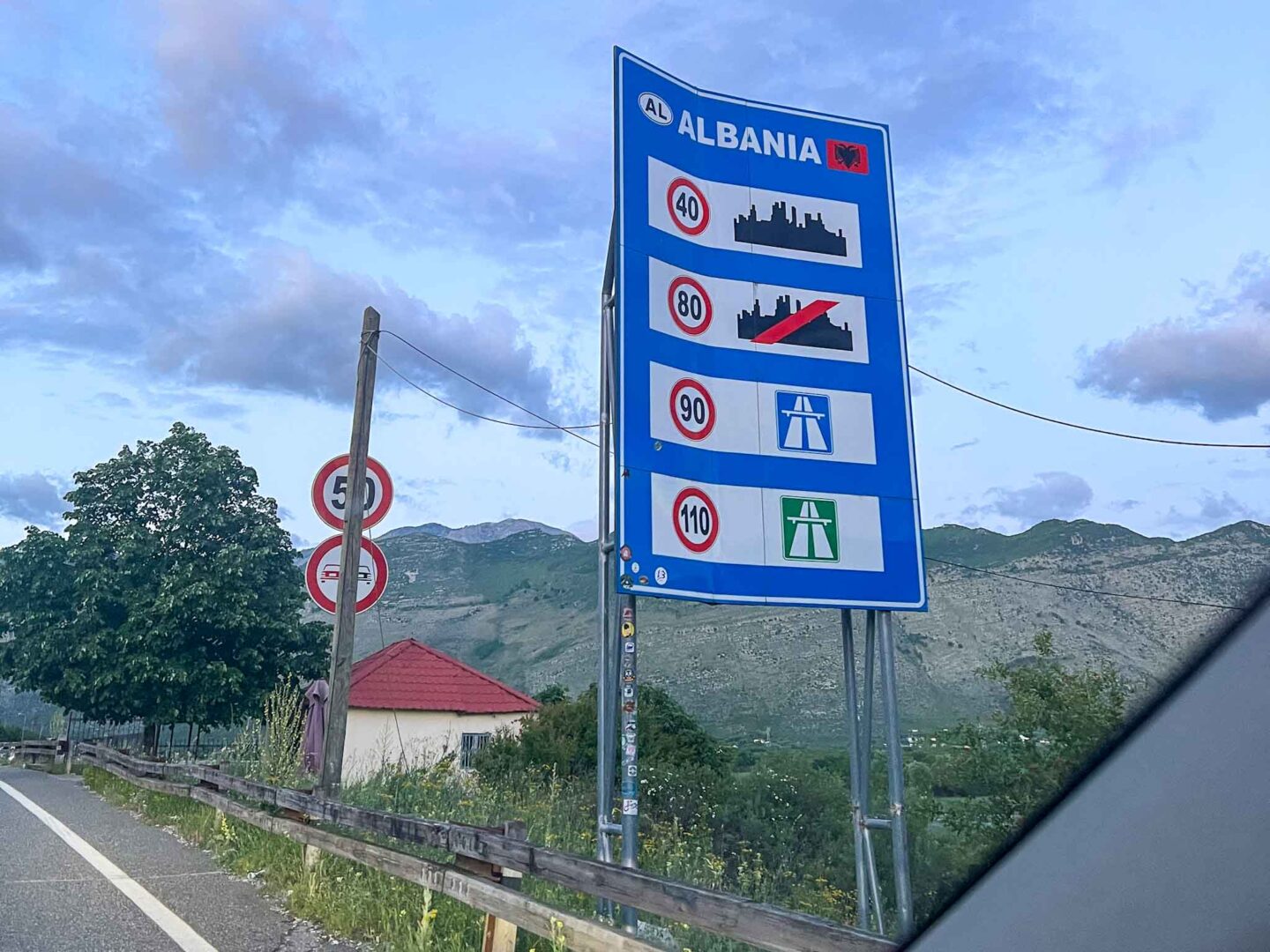 The Wandering Quinn Travel Blog how to get from Montenegro to Albania, border crossing from Montenegro to Albania sign