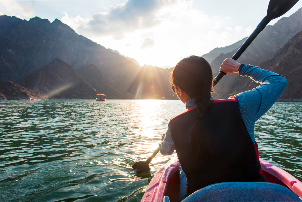 The Wandering Quinn Travel Blog things to do in Hatta, woman kayaking on Hatta lake