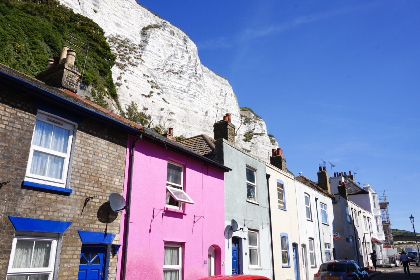 The Wandering Quinn Travel Blog colourful houses with white cliffs behind them