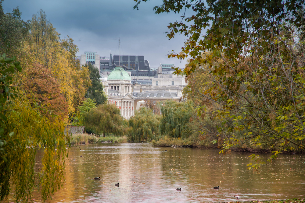best places to visit in Europe in October, London buildings and park lake in autumn colours