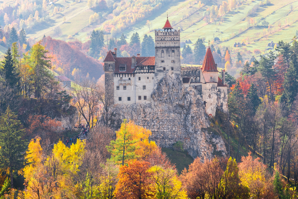 best places to visit in Europe in October, Transalvania castle in October with autumn trees