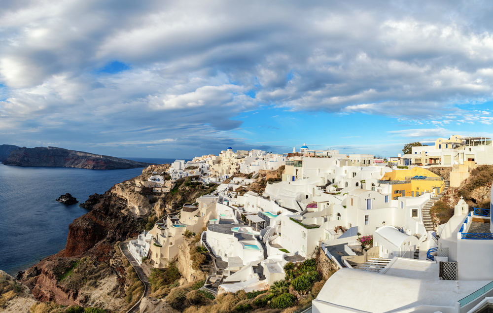 Santorini town view with cloud and sunshine, warm places to visit in December in Europe